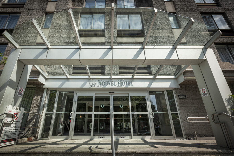 a glass front entrance of a hotel