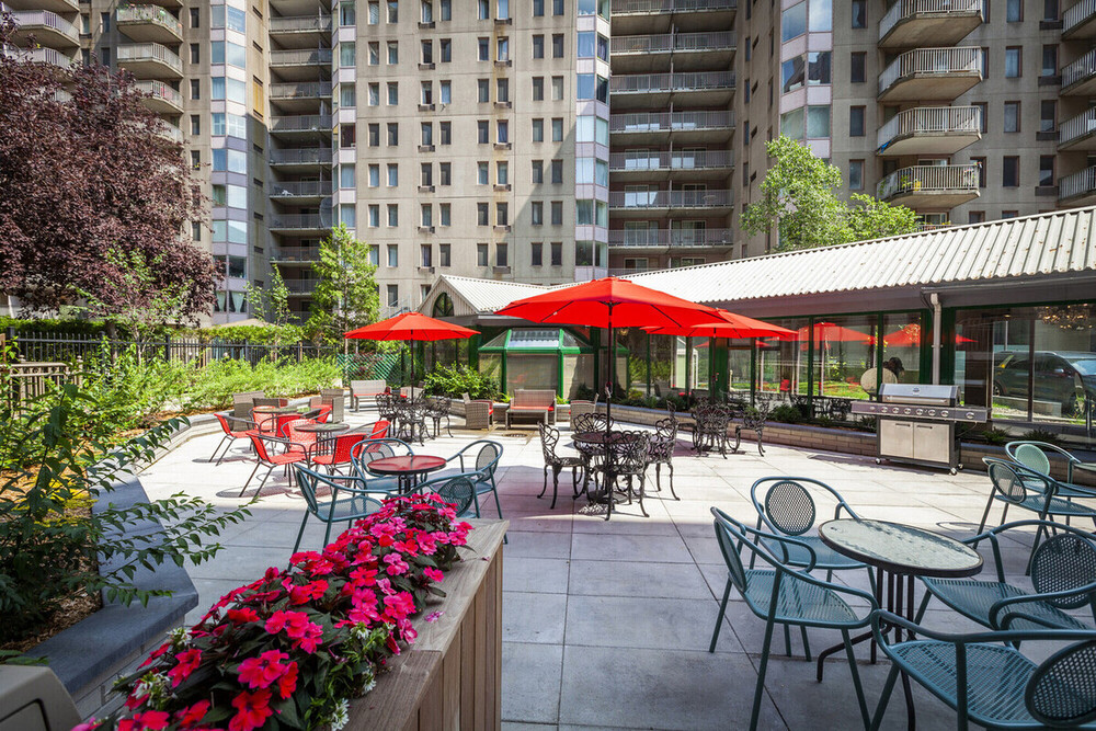 a patio area with tables and umbrellas